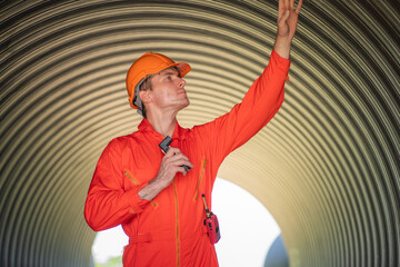 Mechanical engineer wearing safety uniform checking and inspection pipeline system.