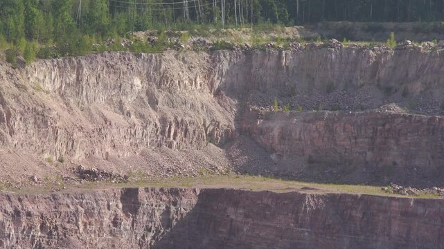Side of a quartzite quarry with different layers of development
