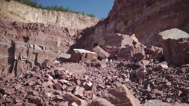 Quartzite stones in a quarry on sunny day close-up truck shot with shallow depth of field
