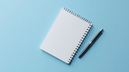 Blank White Spiral Notebook and Black Pen on Light Blue Background