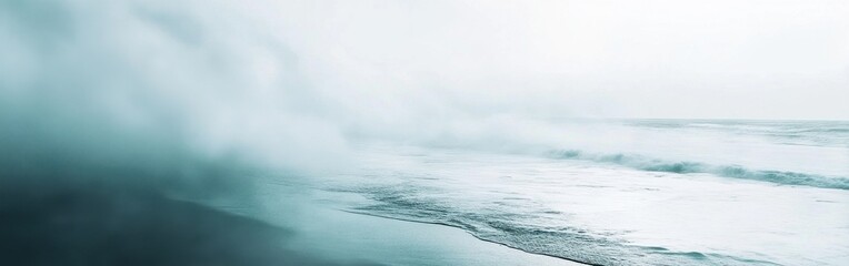 Fototapeta premium Soft pastel mint and gray mist gently dissolving on a sandy beach with gentle ocean waves rolling in under a pale overcast sky