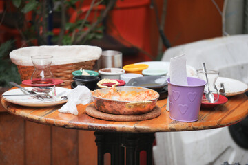 Table with leftover plates and utensils at an outdoor cafe setting