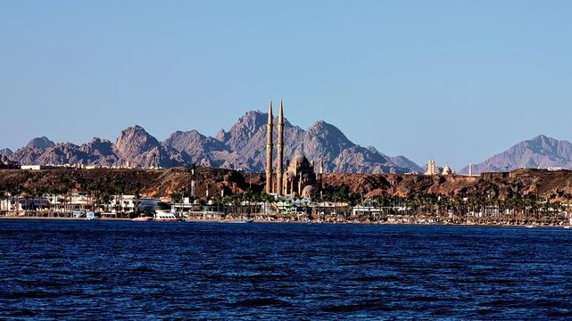 Profile view of Mustafa Mosque with rugged mountains a background with a seafront in Egypt.