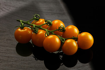 Yellow sweet tomato on the branch