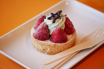 Delicious strawberry tart with cream and chocolate decoration