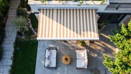 A stylish and modern awning window with striped white and beige canopy on the roof of an outdoor patio area, showcasing its premium design features. 