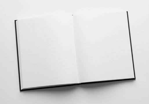 The open book, with its black cover and blank white pages, serves as a symbol of knowledge, learning, or a fresh start