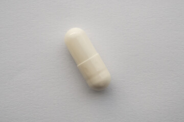 White medicine pill capsule on white background