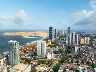Aerial view of Colombo s modern business district and developing port, with tall buildings and oceanfront. High quality image perfect for finance, trade, tourism, and infrastructure projects.