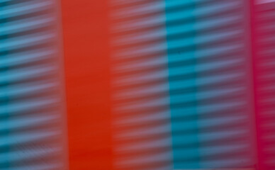 abstract blur of red orange and blue or turquoise corrugated metal special blurry effect created by long time exposure and intentional camera movement horizontal blurred backdrop background wallpaper 