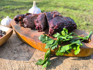 juicy steak on a chopping board surrounded by vegetables and fruits. High quality photo