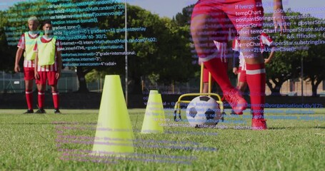 Male soccer players dribbling ball around cones on field, displaying coding overlay for technology - Powered by Adobe