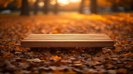 A wooden table rests in a sunlit forest during autumn, surrounded by vibrant fallen leaves in shades of orange and yellow, inviting warmth and serenity