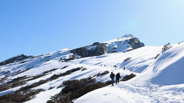 snowcap mountain peak summit with hiking trails and bright sky at afternoon video is taken at Chopta Tungnath Himalayas mountain chandrashila trek uttarakhand india.