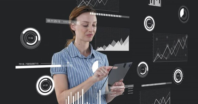 Woman interacting with tablet in studio, showing floating technology data charts and timers