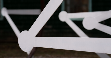close up of white geometrical shapes of  bars with circles on the ends creating triangle shapes...