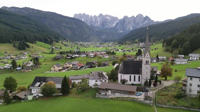 Aerial view of historic church in scenic Gosau village nestled in Austria Alps.