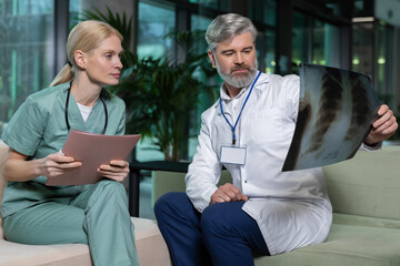 Two doctors sitting next to each other and discussing xray results