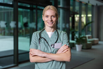 Pretty blonde female doctor looking contented and joyful
