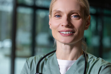 Pretty blonde female doctor looking contented and joyful