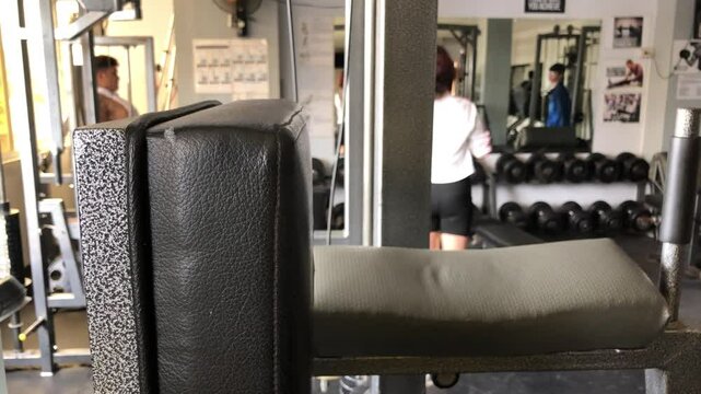 Young people working out inside the gym. Blurs