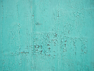 Turquoise wooden surface with cracked peeling paint texture