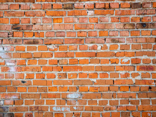 Obraz premium Rustic red brick wall with weathered texture and varied brick patterns