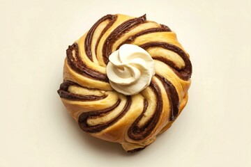 Fototapeta premium A photo of a cooked, baked Cinnabon with a swirl of cream on top