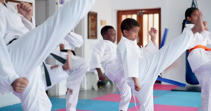 Children, karate and group with fighting or kick for self defense training, taekwondo or martial arts. Kids, learning and practice session with punching or technique for kata or lesson in aikido dojo