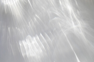 Abstract shadows background from pouring sunlight top view. Natural caustic background from light glare and shine reflection effects for product presentation.