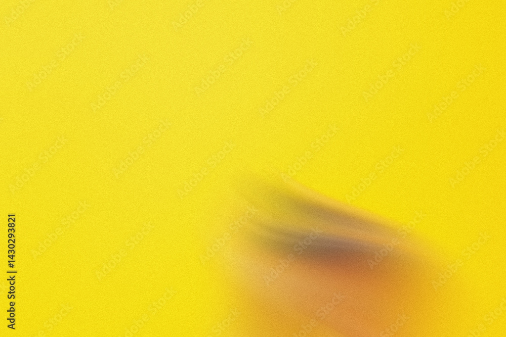 Poster a blurred image featuring a hand against a bright yellow background creating a simple abstract desig