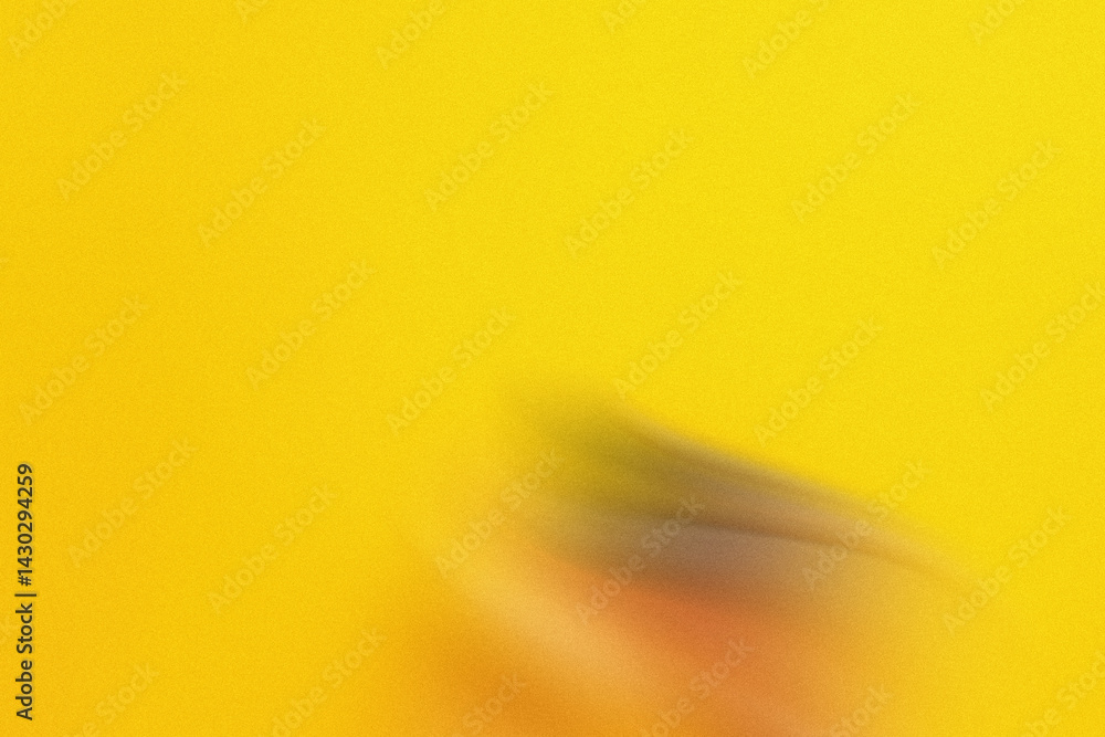 Poster a blurry image featuring a soft yellow background with a dark shape in the lower right corner of the