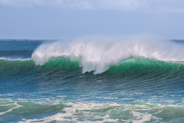 A powerful turquoise wave crashes at Snapper Rocks, Coolangatta, Queensland, its misty whitewater spraying into the air, capturing the raw energy and unstoppable force of the ocean.