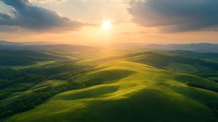 Fototapeta premium Aerial View of Rolling Hills at Sunset, A breathtaking aerial view of rolling green hills under a dramatic sky with the sun setting