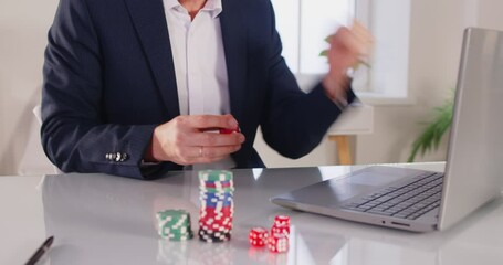 Close up shot of a man celebrates success after playing online gambling or poker on laptop, achieving win in casino setting, filled with excitement during the moment of victory in a digital space.