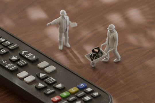 Miniature figurines working on a remote control in a 3D conceptual scene