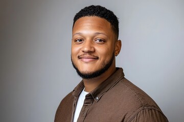 A Brazilian man in his 30s is depicted against a white background, wearing a stylish cardigan