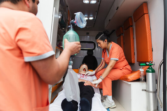 Nurses providing emergency care to a patient inside an ambulance