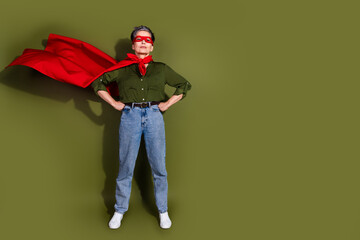 Confident elderly woman standing in superhero attire symbolizing empowerment and individuality