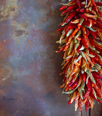 Bunch of chile peppers red and green huing a sa chile ristra a traditional way to store peppers or...