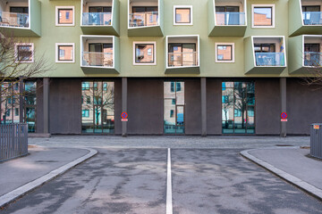 Contemporary green facade with balconies and clean textures in Copenhagen, rich in color and symmetry, perfect for sustainability and urban renewal themes.