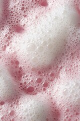Fototapeta premium A top-down view of a pink background showcases various cosmetic products, including foamy soap lather, a clear spot of aloe vera, moisturizer for the face, body milk lotion, and lipstick with visible