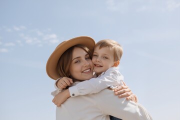 A tender moment captured outdoors, showing a mother and son in a loving embrace