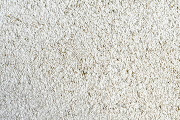 Dirty old stucco white concrete paint wall with green yellow mold stains. Grunge and rough surface.