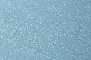 Many water drops on light blue background