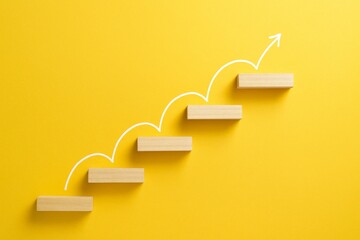 Ascension: A visual representation of growth and advancement, showcasing wooden blocks arranged as steps with an upward-curving arrow