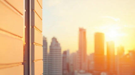 Sunlight streams across the urban skyline illuminating skyscrapers and buildings blur into a golden horizon seen from the side of a modern structure with panels.