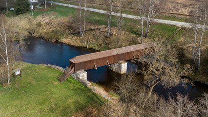 The picturesque covered wooden bridge Rechle near Lenora in the Šumava mountains – a unique national cultural monument - historic bridge with a wooden deck and stone pillars
