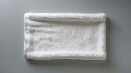 Gray background with a white towel mockup from a top view