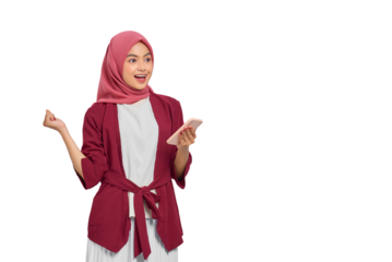 Happy young Asian Muslim woman in hijab holding smartphone and gesturing with hand isolated on transparent background